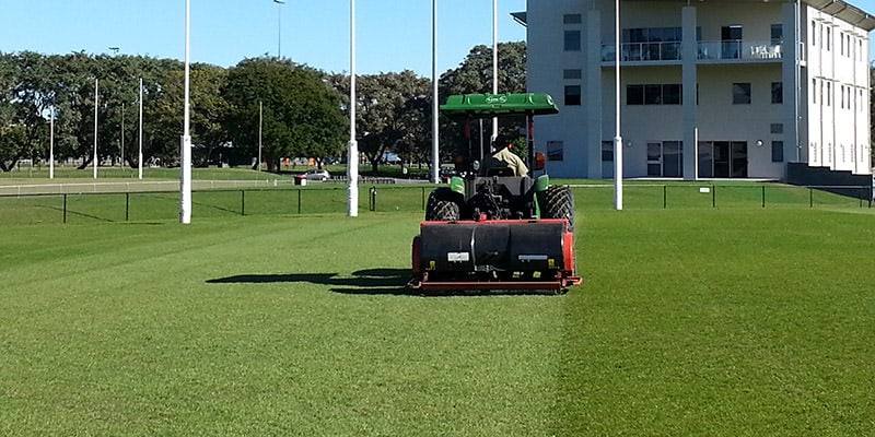 All Grass Solutions tractor aerating a football oval